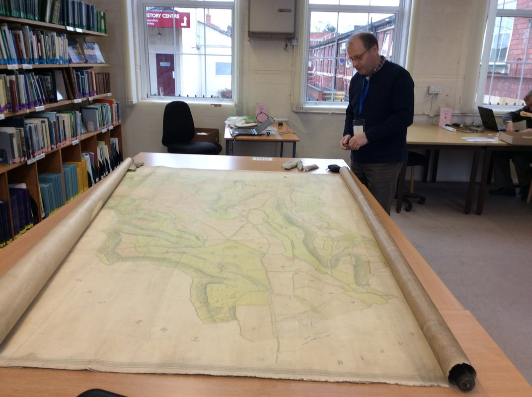 Former Churchwarden Mike Lambert with Baker’s map of the Lypiatts, at Gloucestershire Archives in 2014